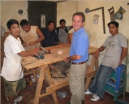 A picture of boys at workbenches making cedar boxes.